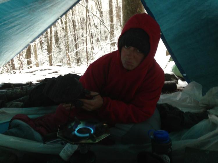 Thawing out my frozen boots over a backcountry stove.